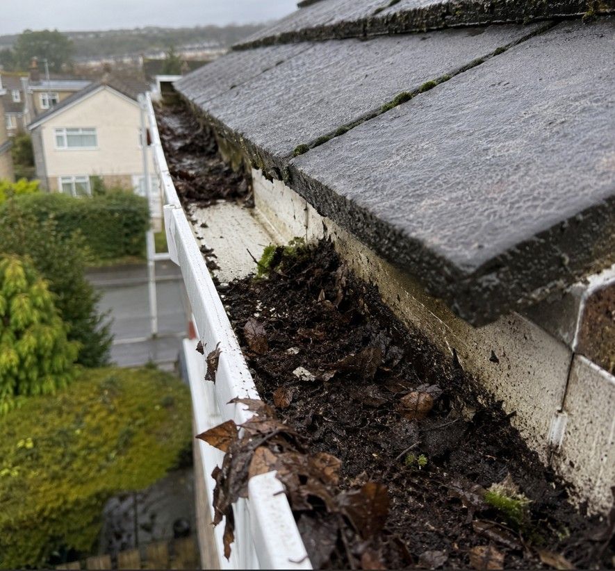 J&Z Property Maintenance clearing a blocked gutter at a Barry home