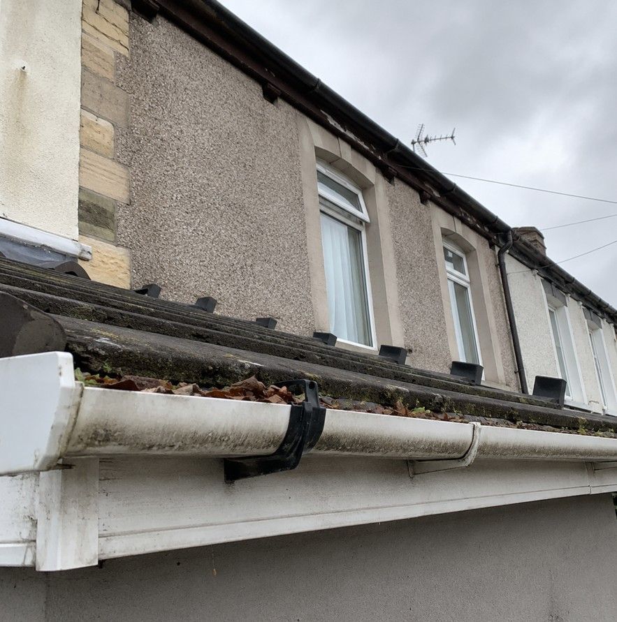 J&Z Property Maintenance cleaning and repairing gutters at a Barry property