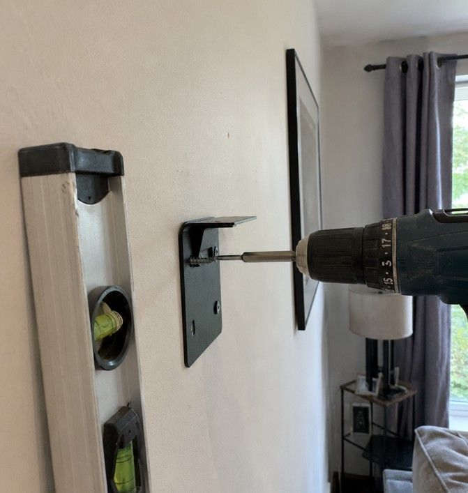 J&Z Property Maintenance handyman mounting a TV on a wall in Barry