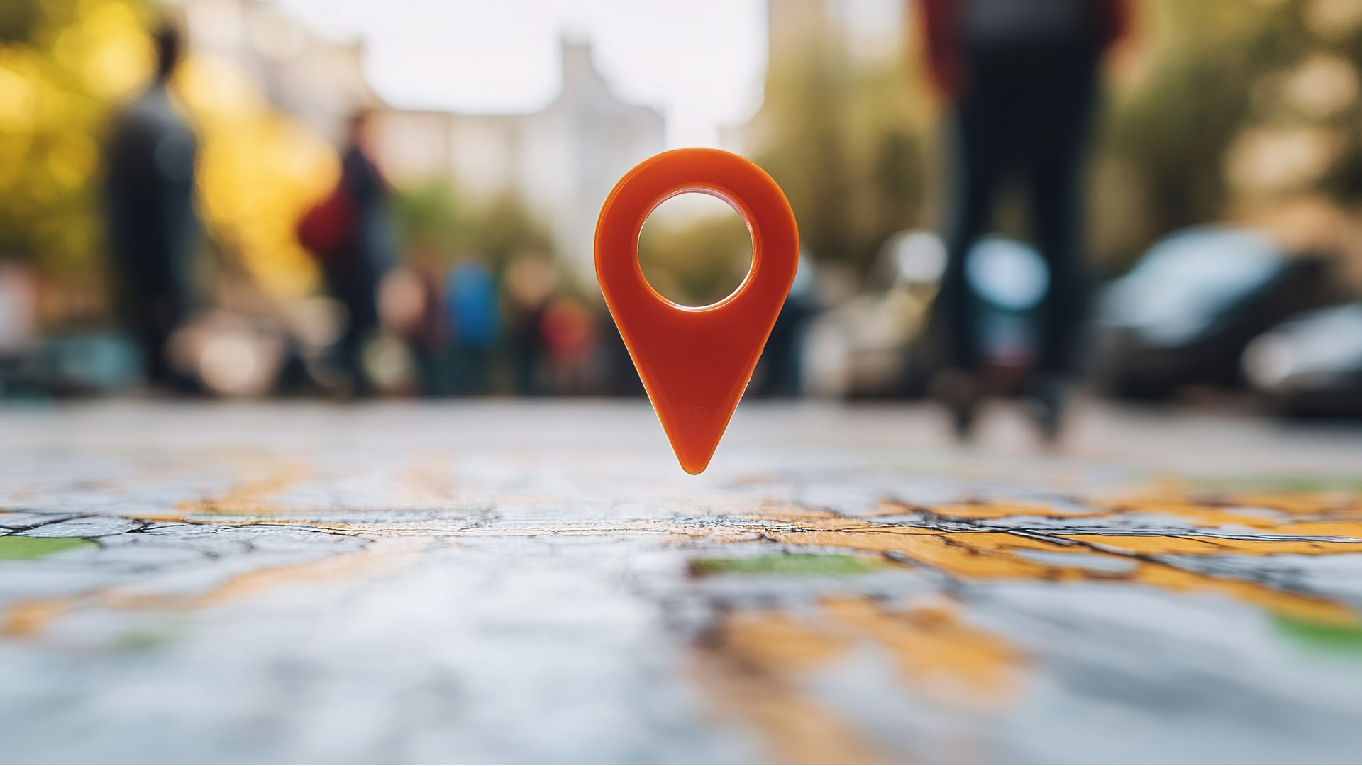 Red map pin on a blurred street map, with city background out of focus.