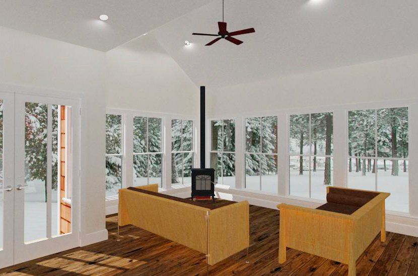 Modern living room with wood floor, wood furniture, a black stove, and large windows overlooking snowy trees