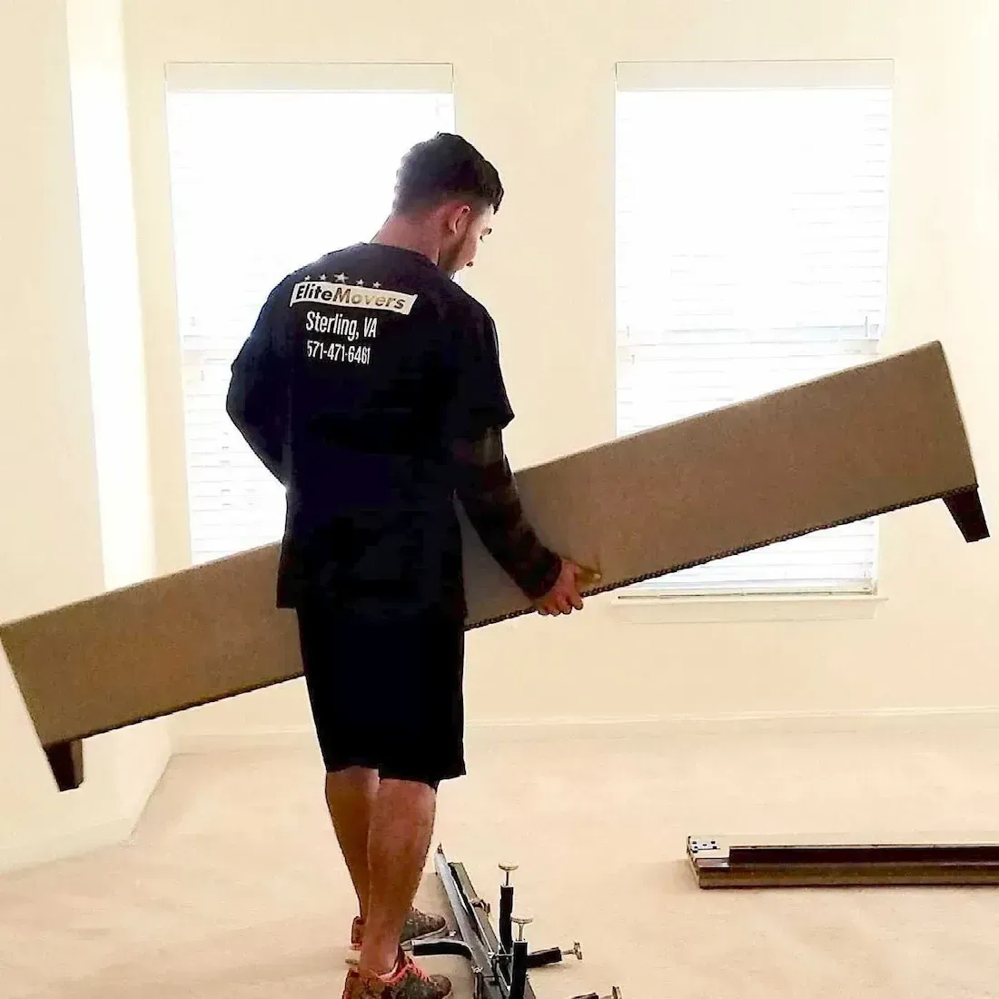 an employee is holding bed frame