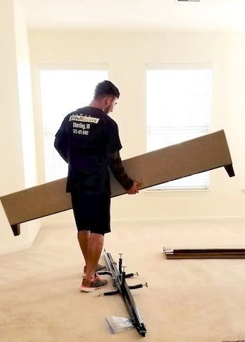 an employee holding a bed frame