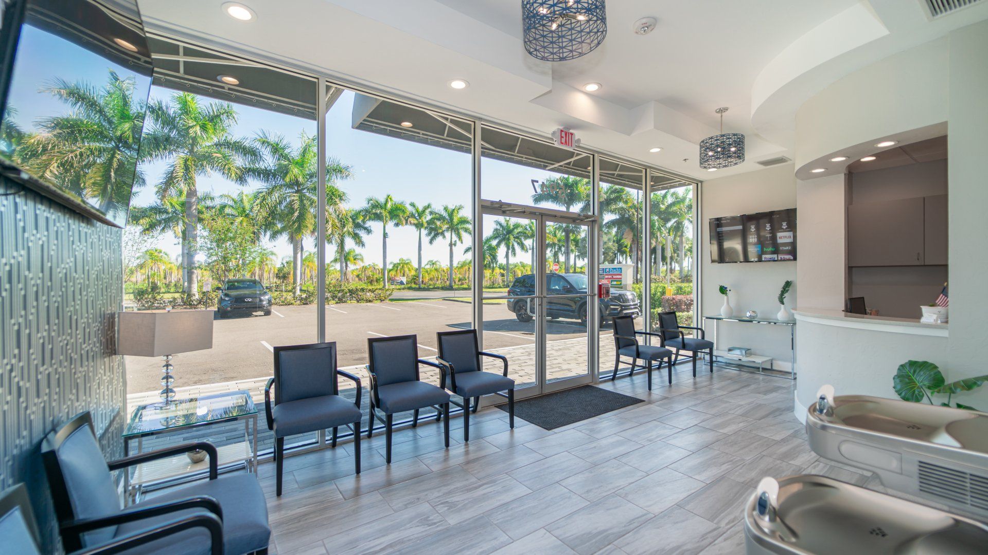 A waiting room with a lot of chairs and a large window.