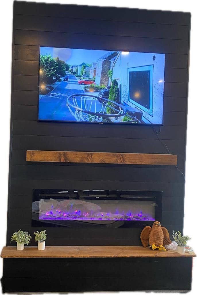 A fireplace with a flat screen tv above it.