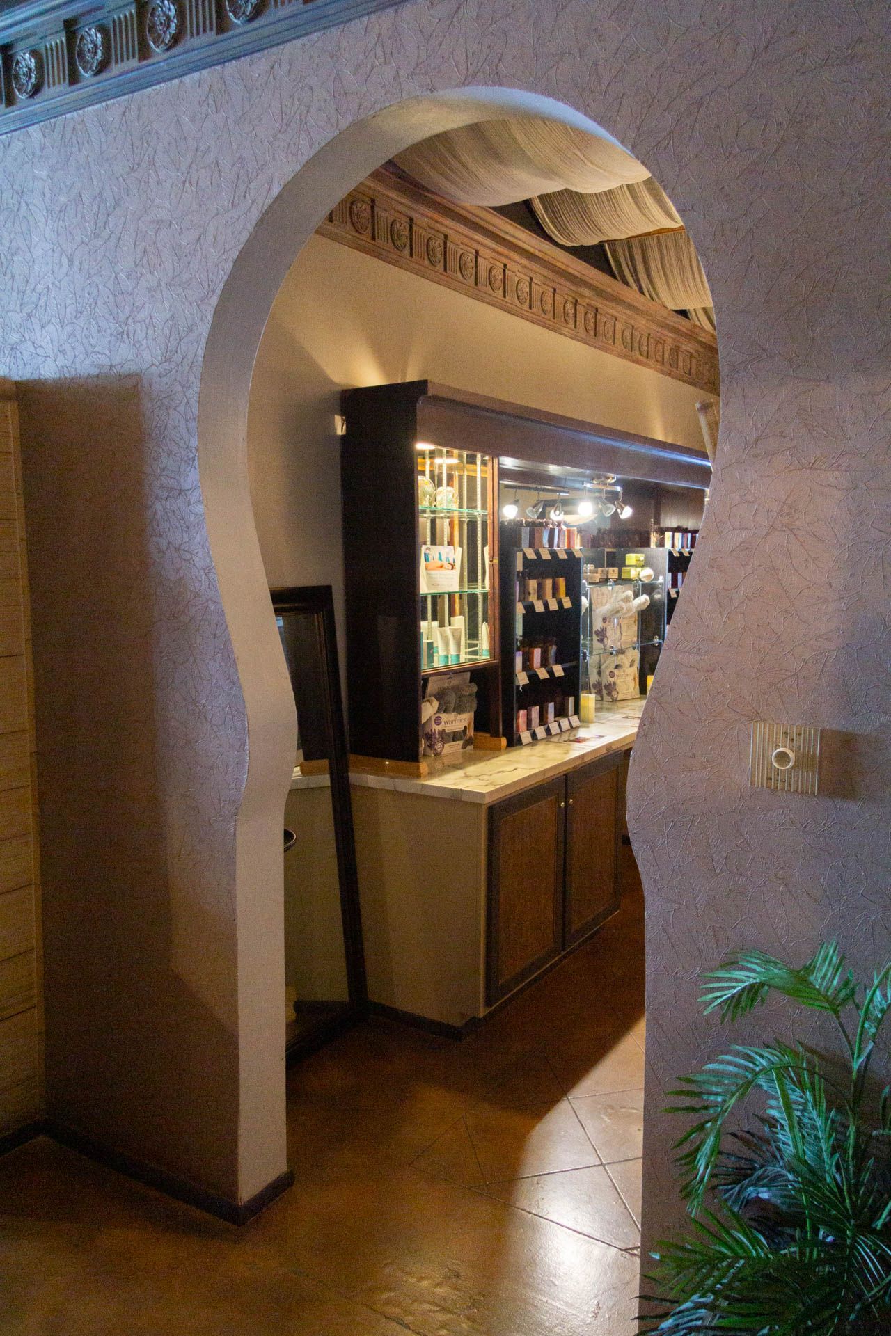 a room with a curved archway leading to a bar .