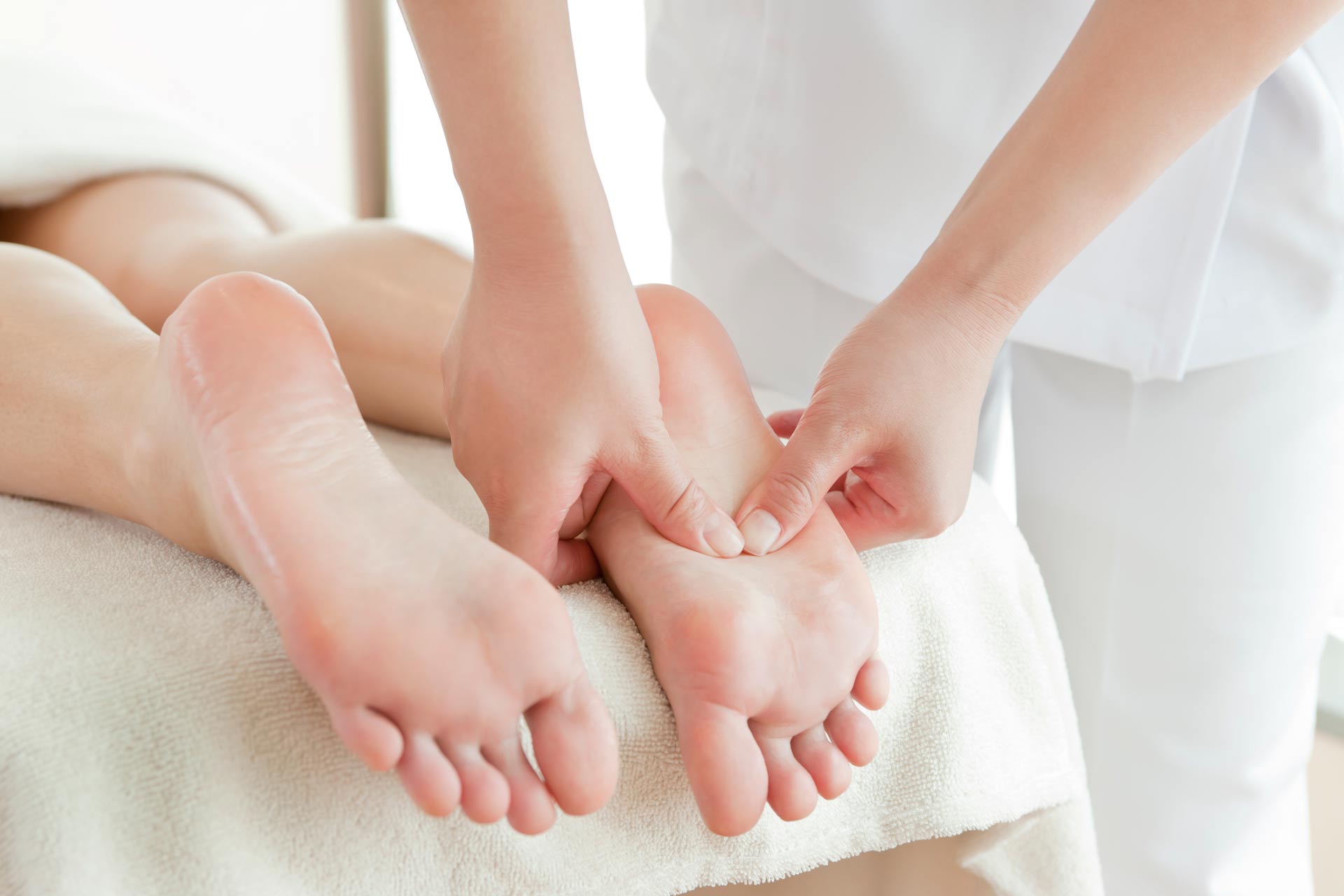 woman receives a reflexology treatment in salon