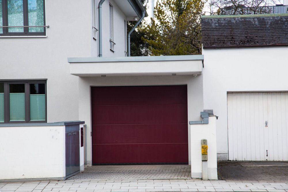 Front View Of A White House With A Red Garage Door — Lighthouse Beach Garage Door Service in Port Macquarie, NSW