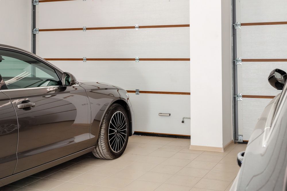 A Car Is Parked In A Garage Next To A Garage Door — Lighthouse Beach Garage Door Service in Port Macquarie, NSW