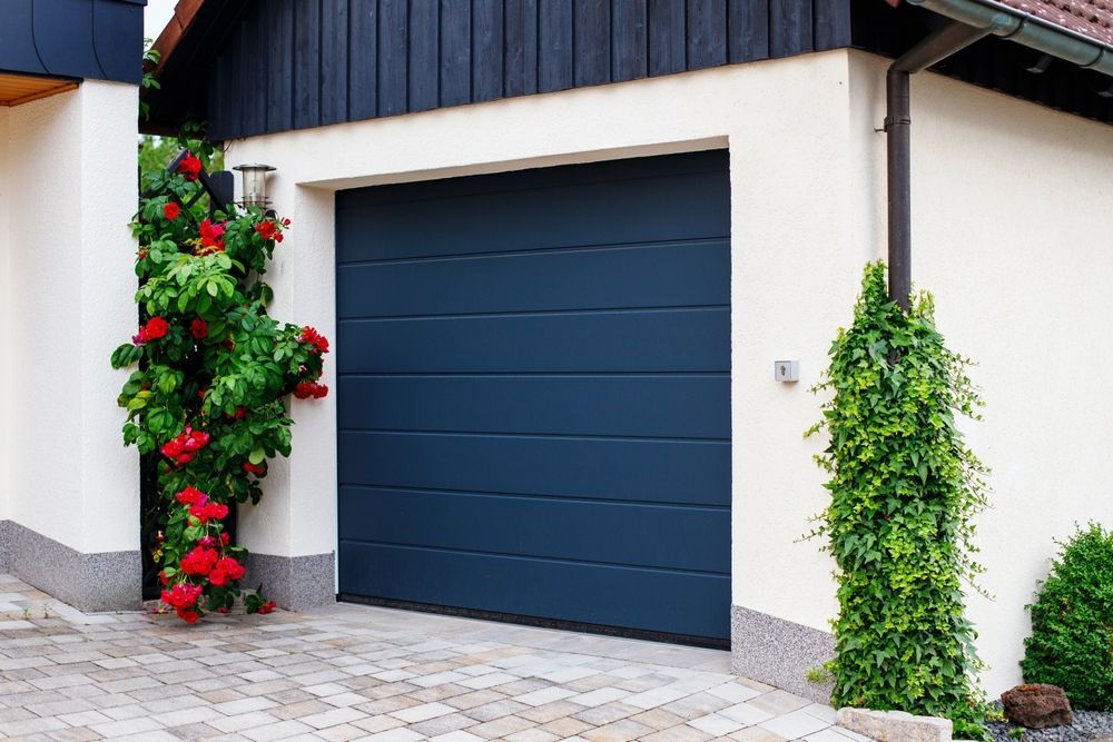 White House Exterior With a Dark Blue Garage Door — Lighthouse Beach Garage Door Service in Port Macquarie, NSW