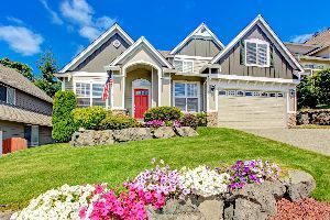 A large house with a lot of flowers in front of it.