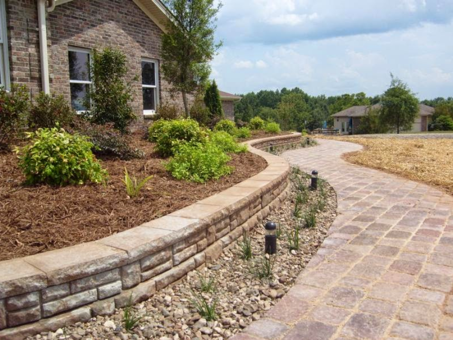 A brick walkway leading to a brick house