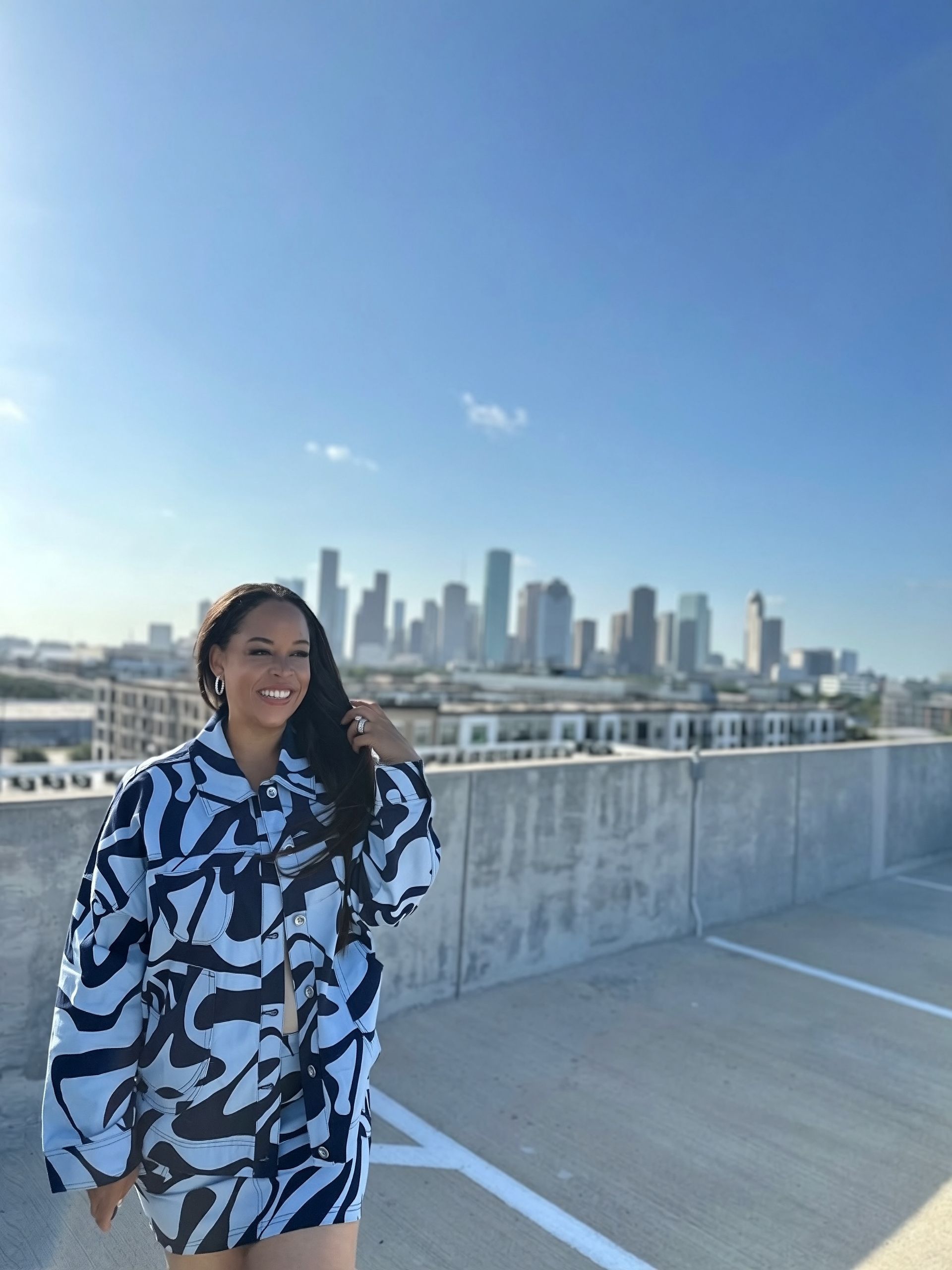 The Blue Print coordinated outfit — alternate pose against the Houston skyline