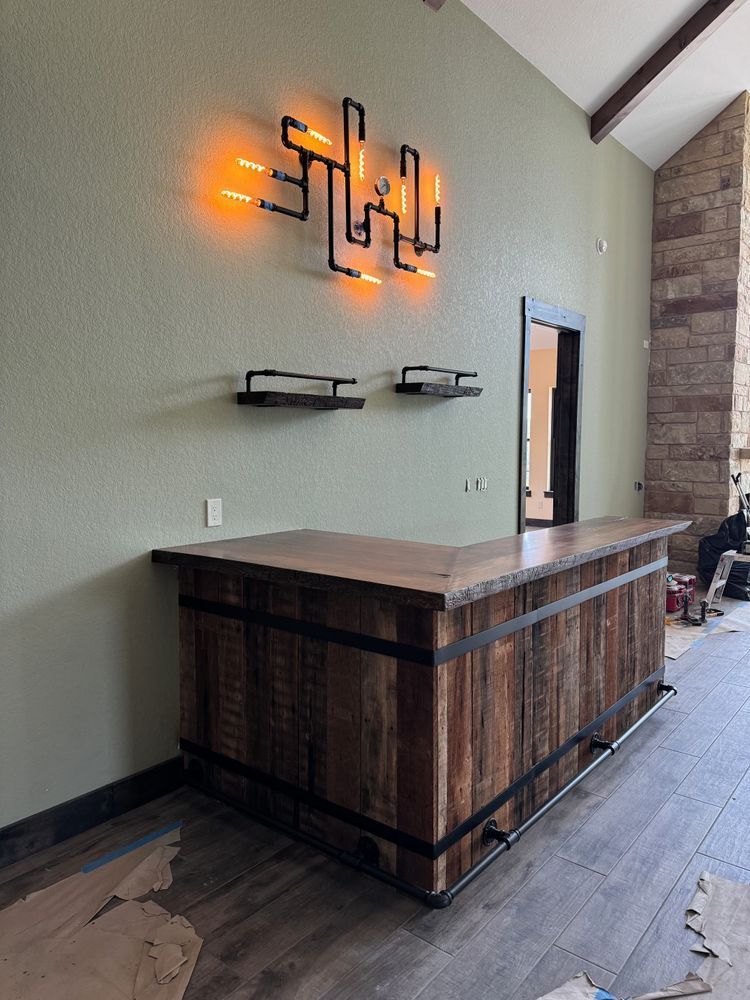 Empty modern lobby with wood reception desk and glowing wall art on a tan wall