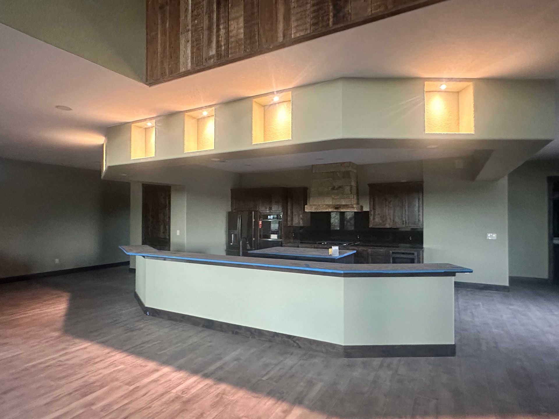 Empty hotel lobby with a curved reception desk and warm ceiling lights