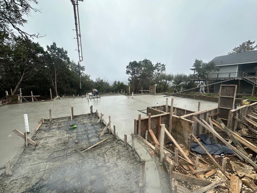 Concrete road under construction with wooden formwork and debris on both sides