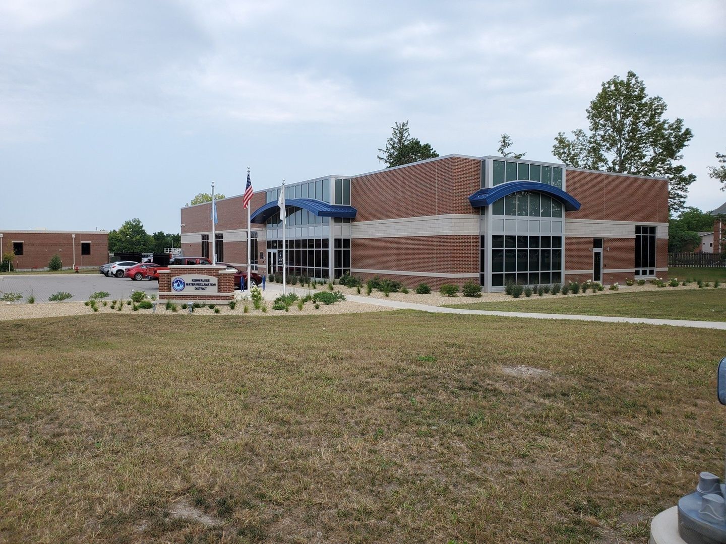 A large brick building with a fire hydrant in front of it