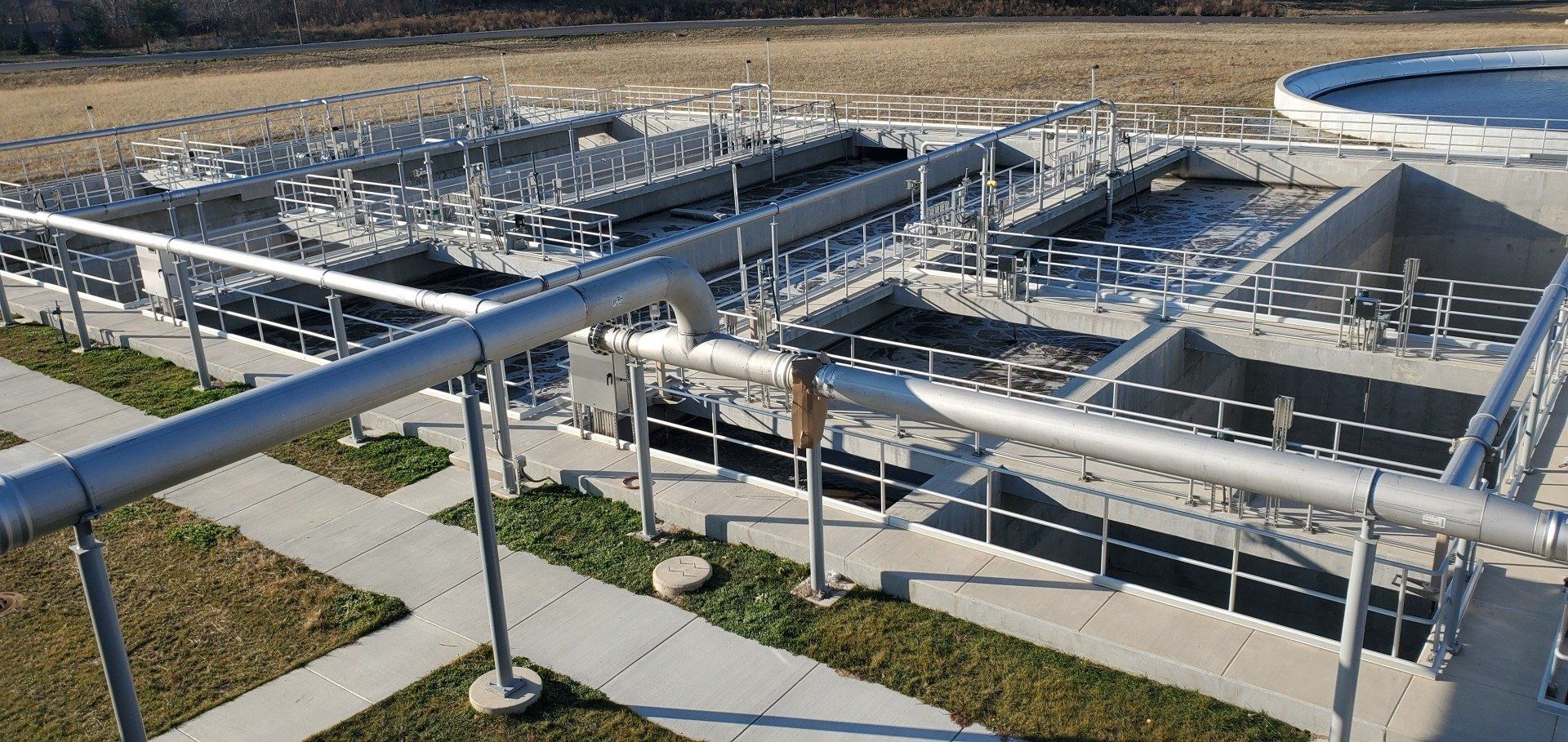 A large concrete structure with a lot of pipes going through it.