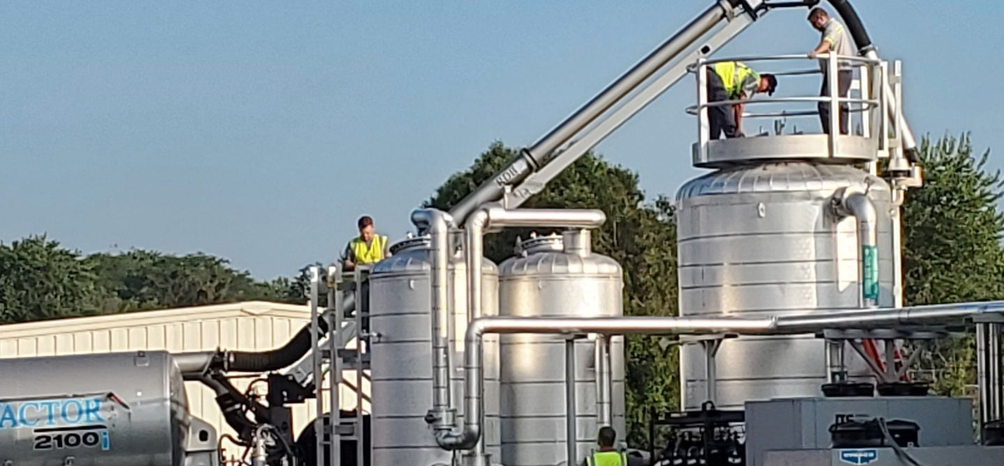 A group of people are working on a large metal structure.