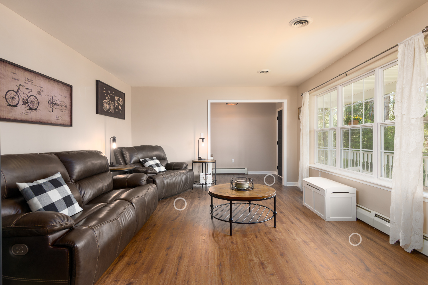 A living room with two couches , a coffee table , and a large window.
