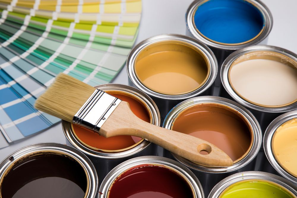 Paint Cans in Various Colors with A Paintbrush and Color Swatch Fan — Frenchy’s Plaster & Paint in Bellamack, NT