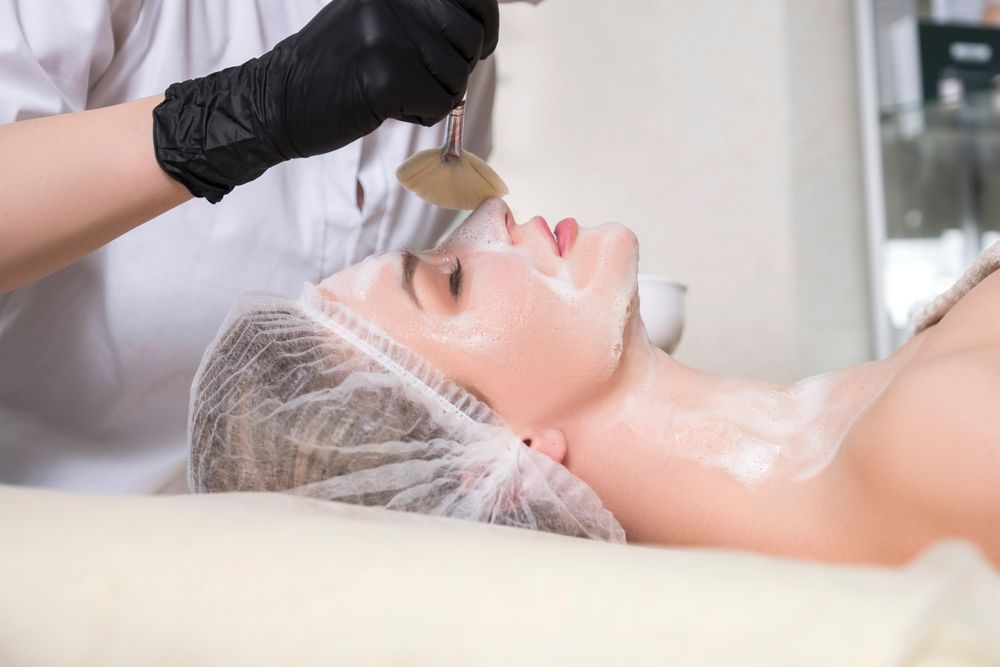 A Woman is Getting a Facial Treatment at a Spa — Gorjess Aesthetics in Corrimal, NSW