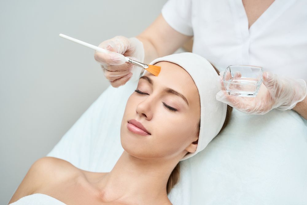 A Woman is Getting a Facial Treatment at a Spa — Gorjess Aesthetics in Corrimal, NSW