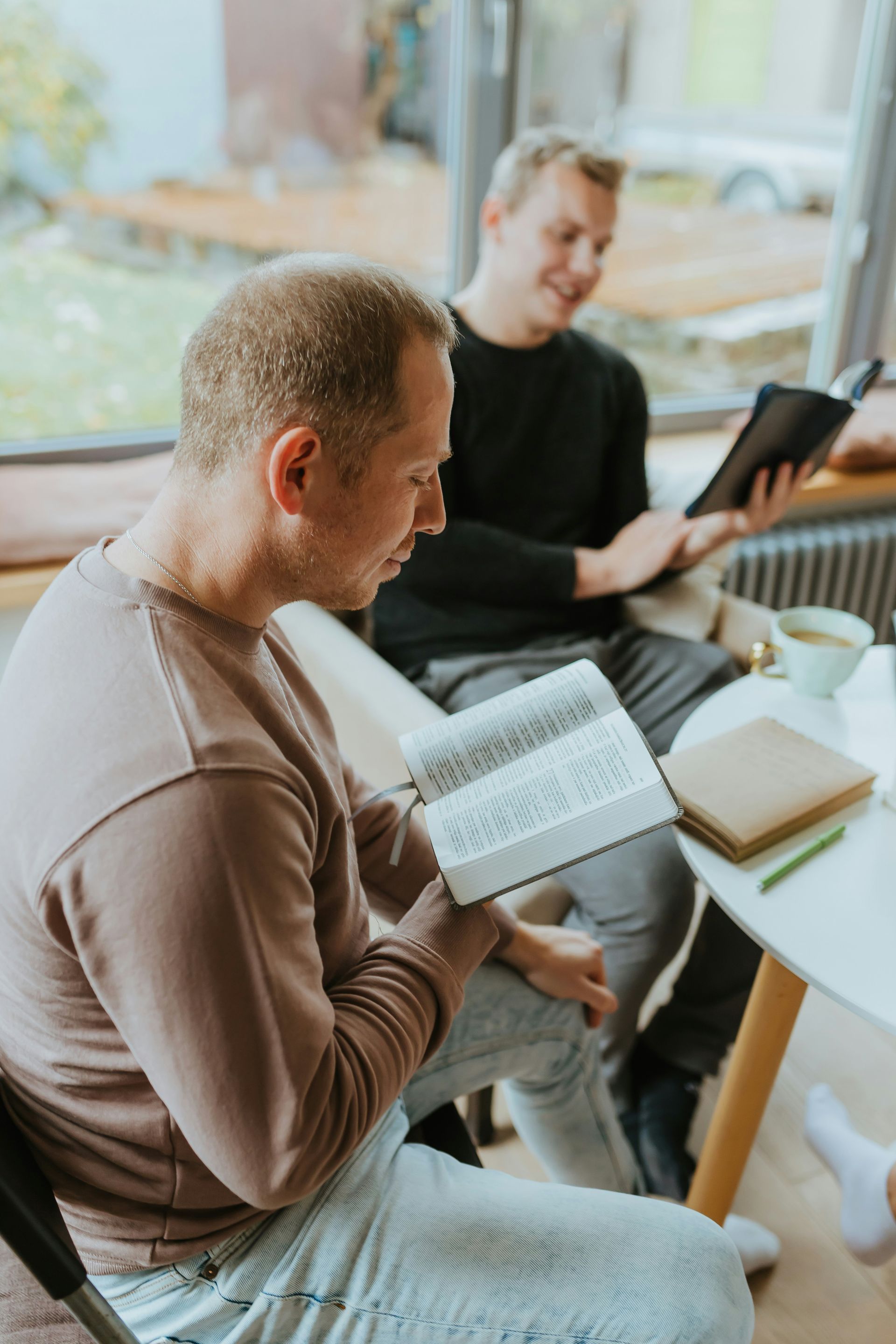 A group of men are sitting and studying the bible