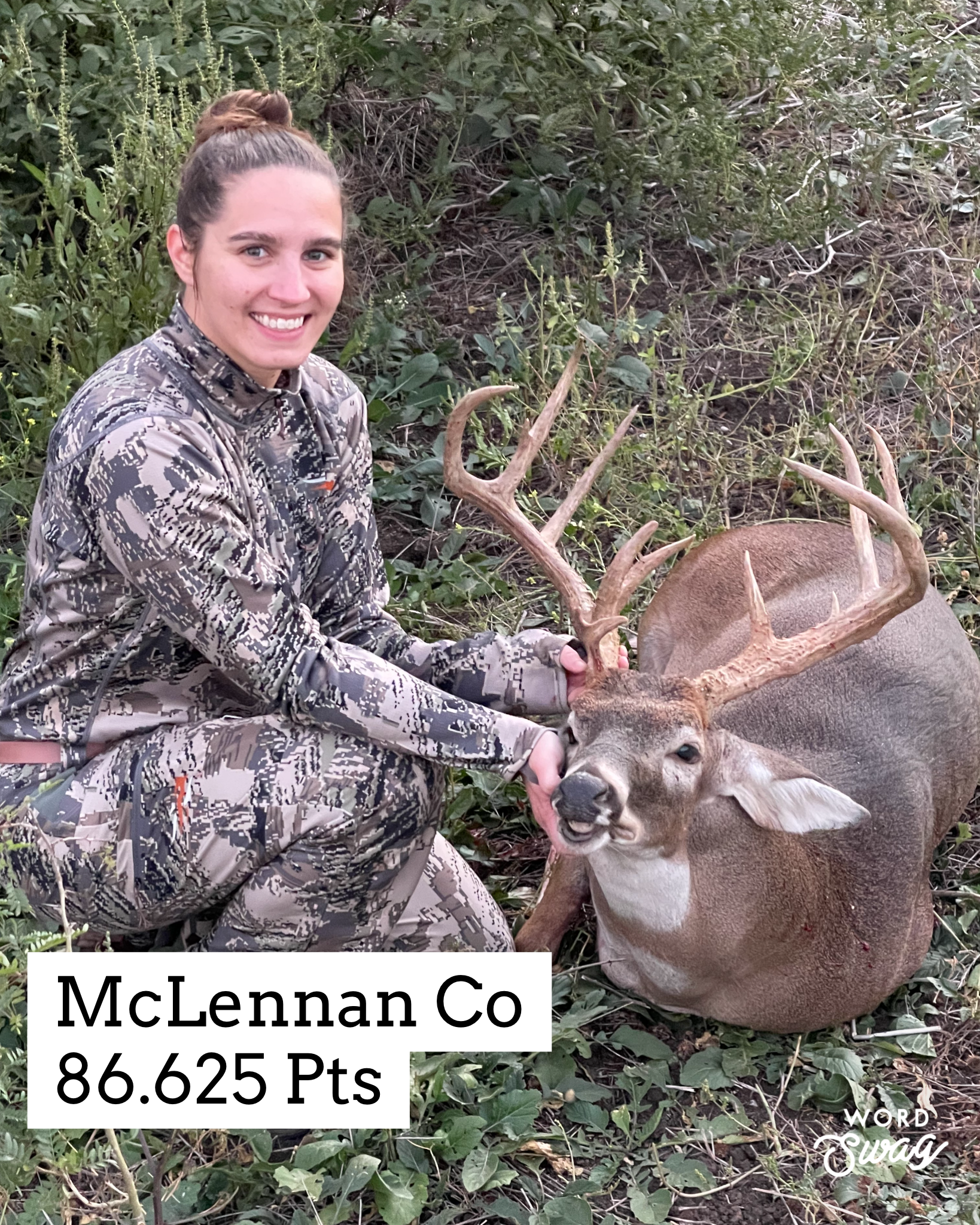 Woman in camo kneels beside a large buck with antlers in McLennan County, Texas. She smiles.