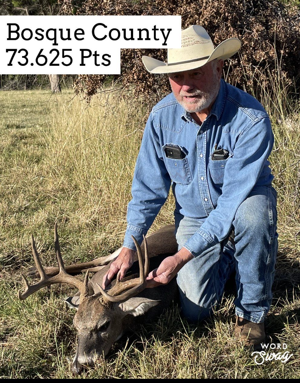 Man in cowboy hat with a deer in Bosque County, Texas. He is kneeling beside it, with a score of 73.625.