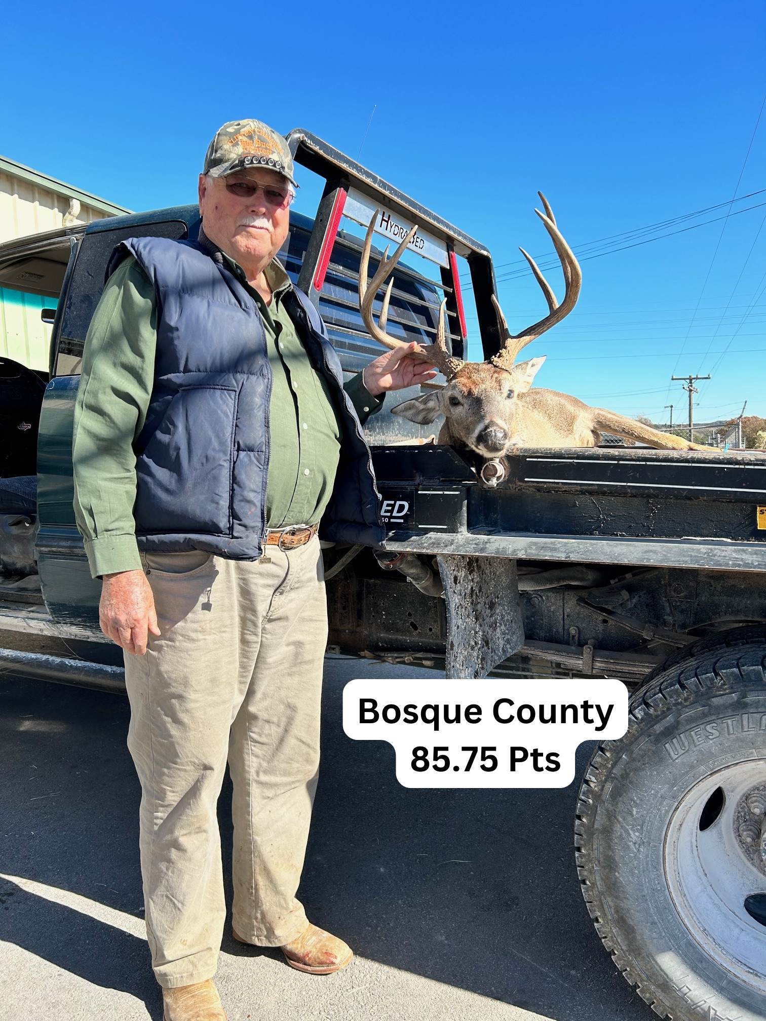 Man poses with a buck in a truck bed in Bosque County, Texas. The deer scored 85.75 points.