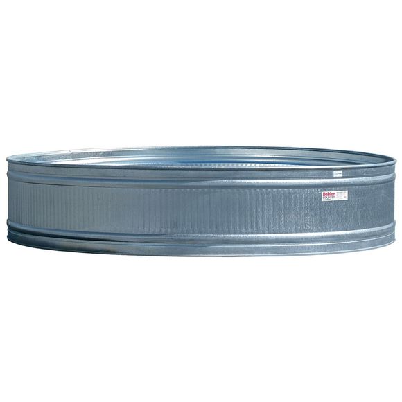 A large metal barrel is sitting on a white surface.