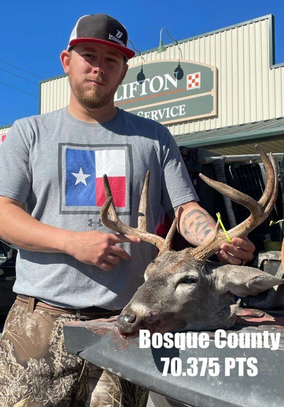 Man holding deer head, Bosque County, 70.375 pts, in front of 