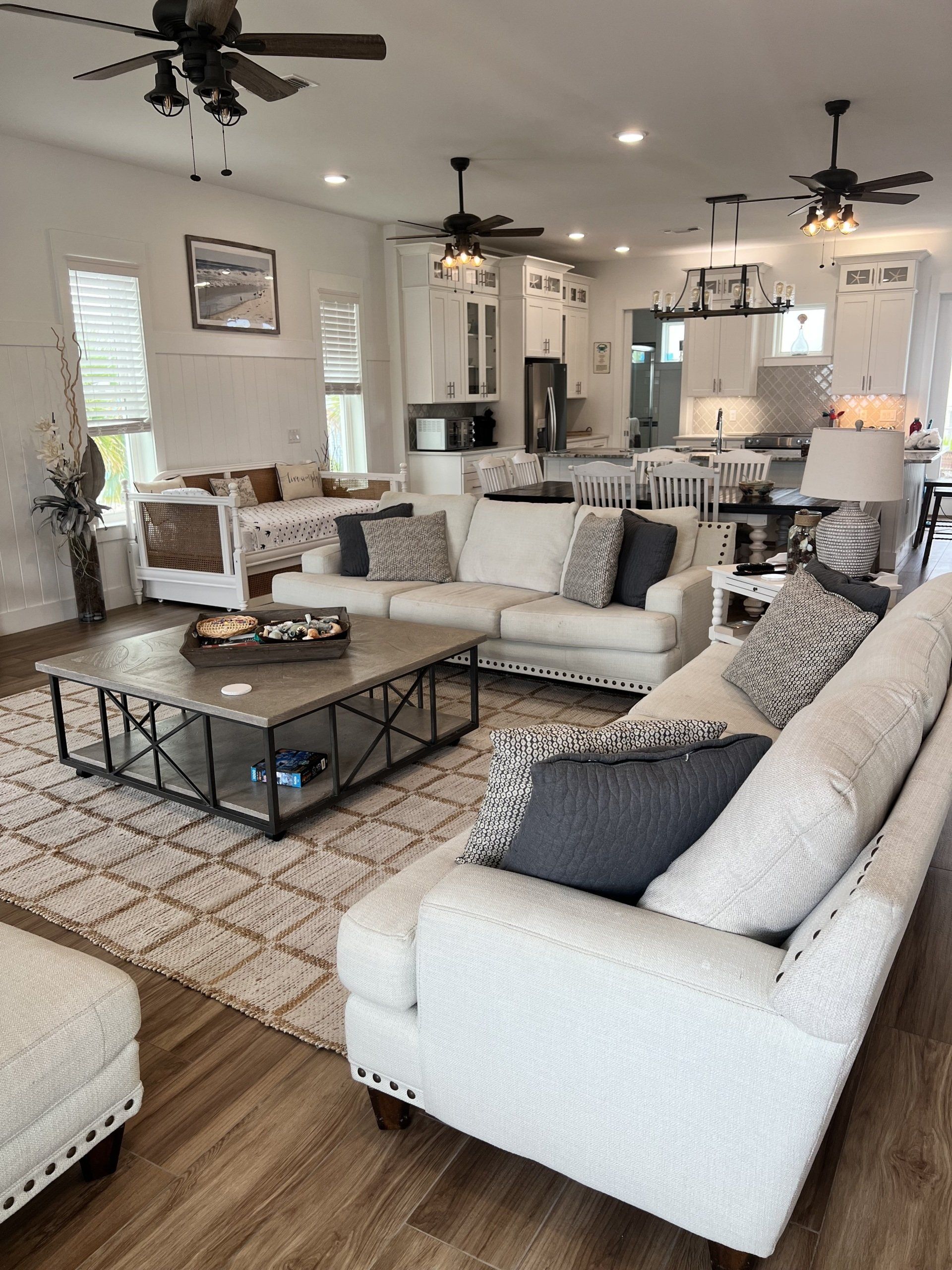 A living room filled with furniture and a ceiling fan.