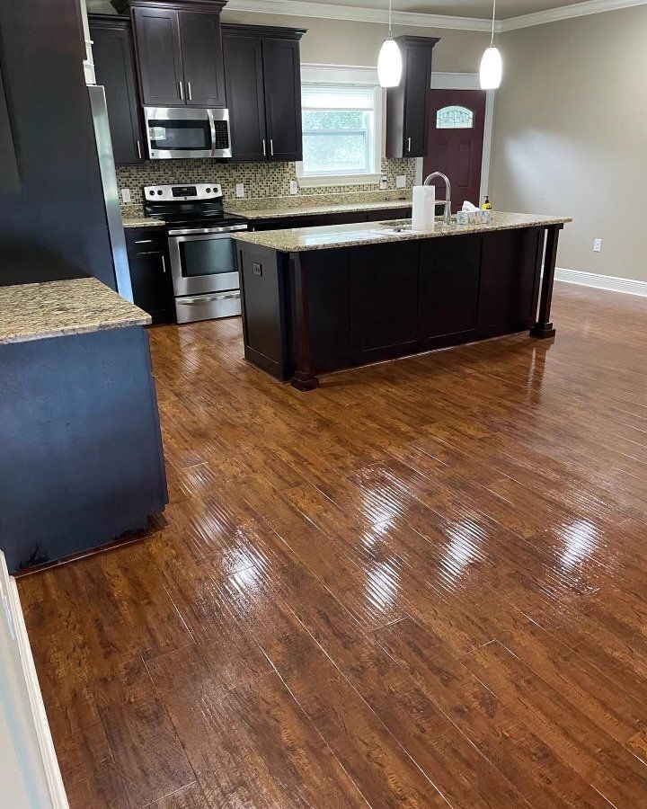 A kitchen with hardwood floors and stainless steel appliances.