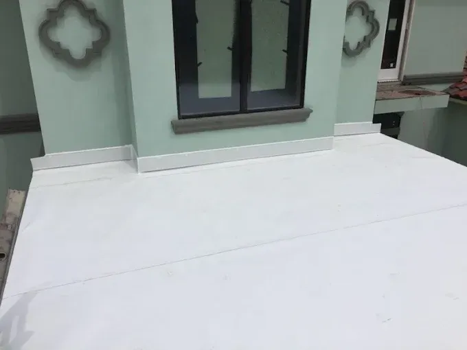 White painted platform with window, light green wall, and decorative trim.