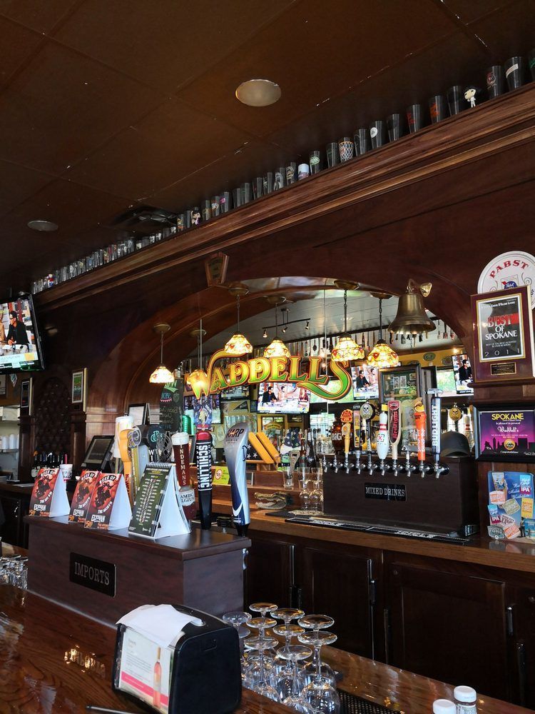 A bar with a sign that says apples on it