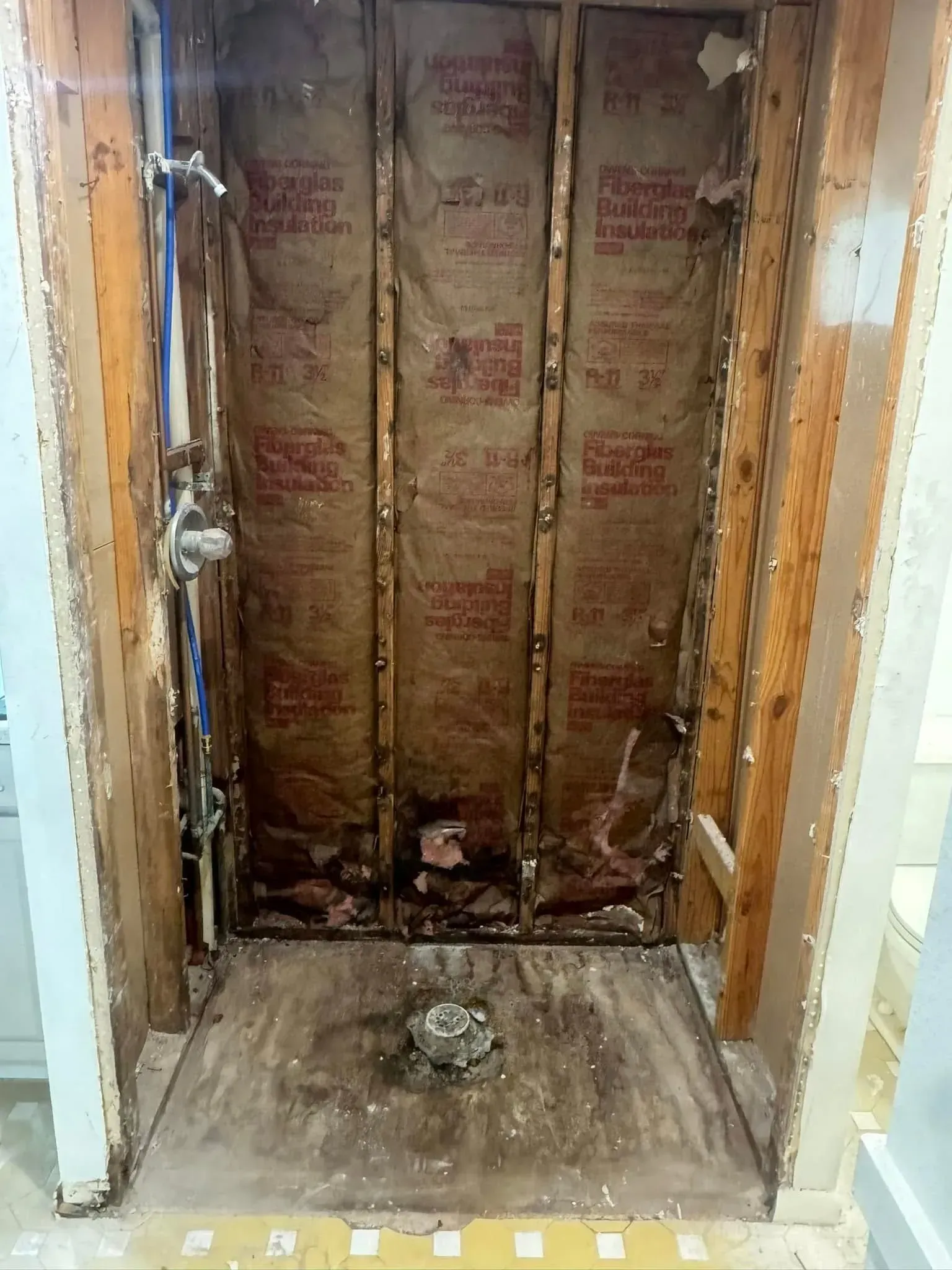 A shower stall is being remodeled in a bathroom.