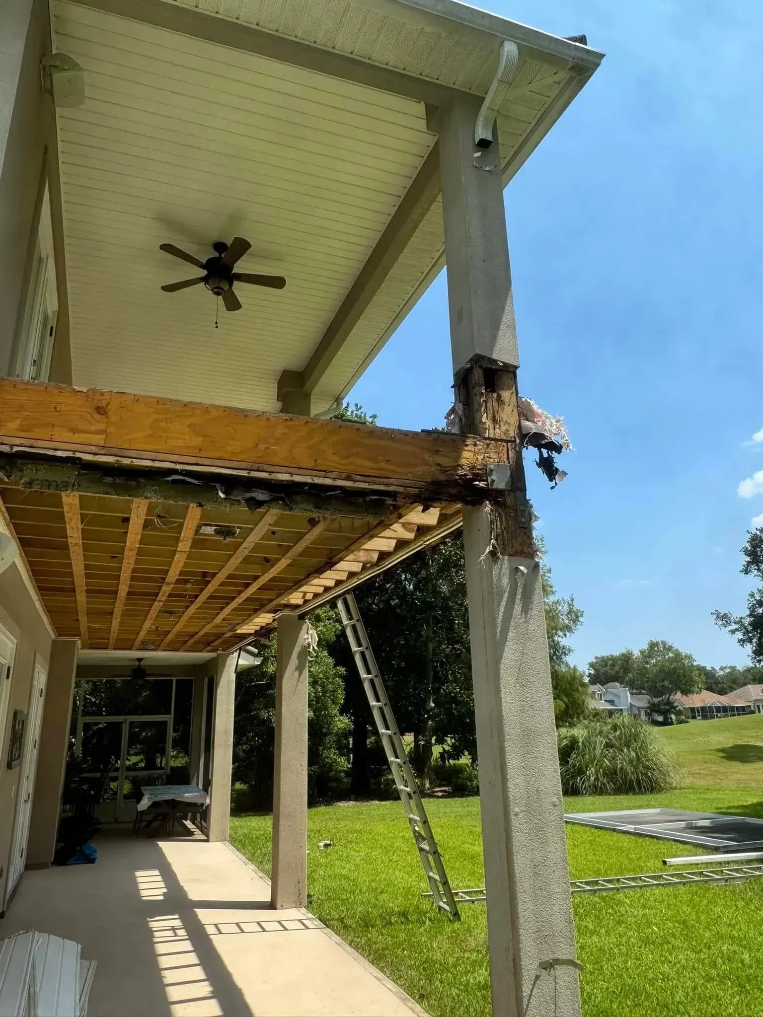 A wooden deck is being built on the side of a house.