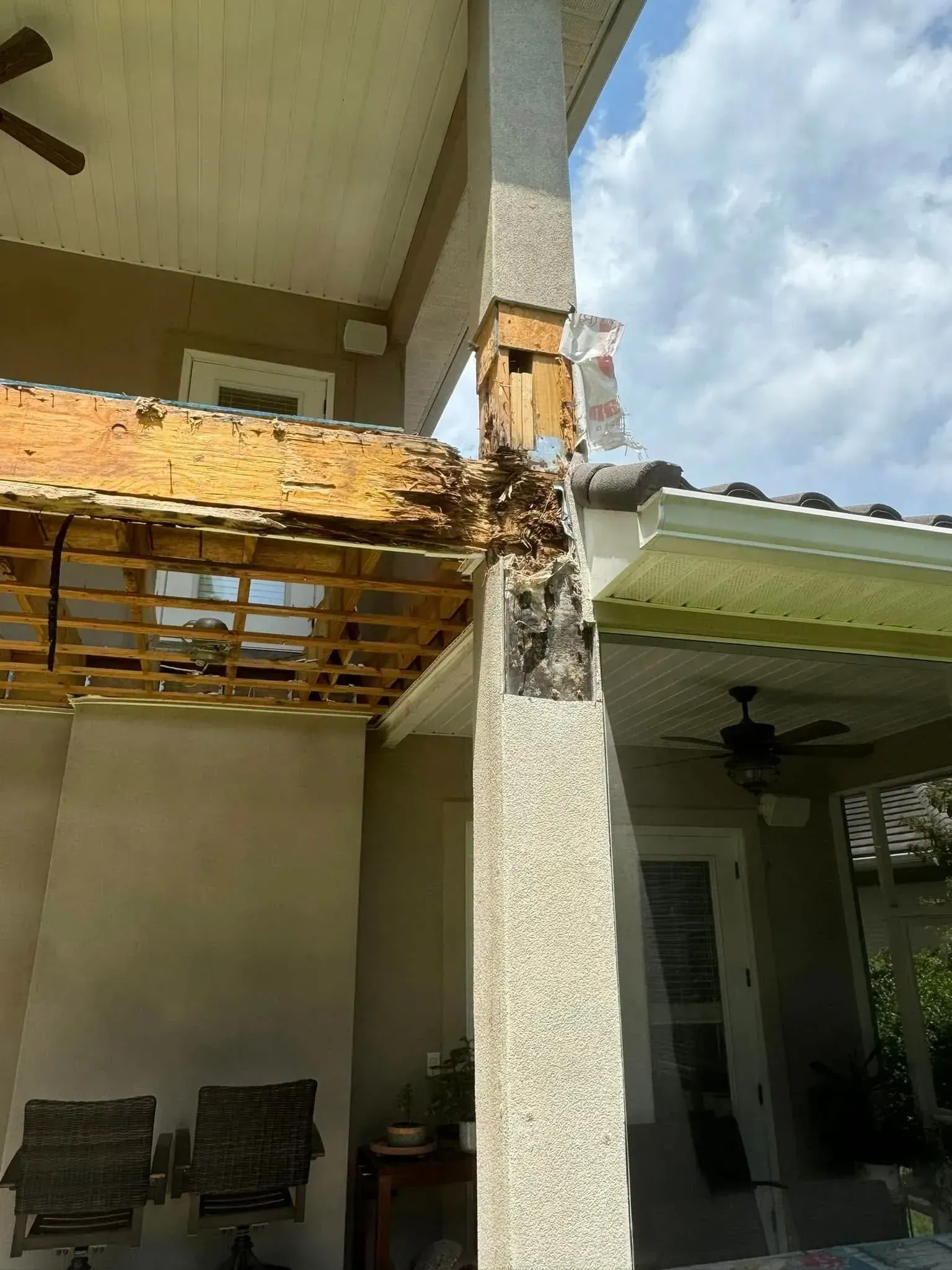 A house with a roof that has been damaged by a storm.