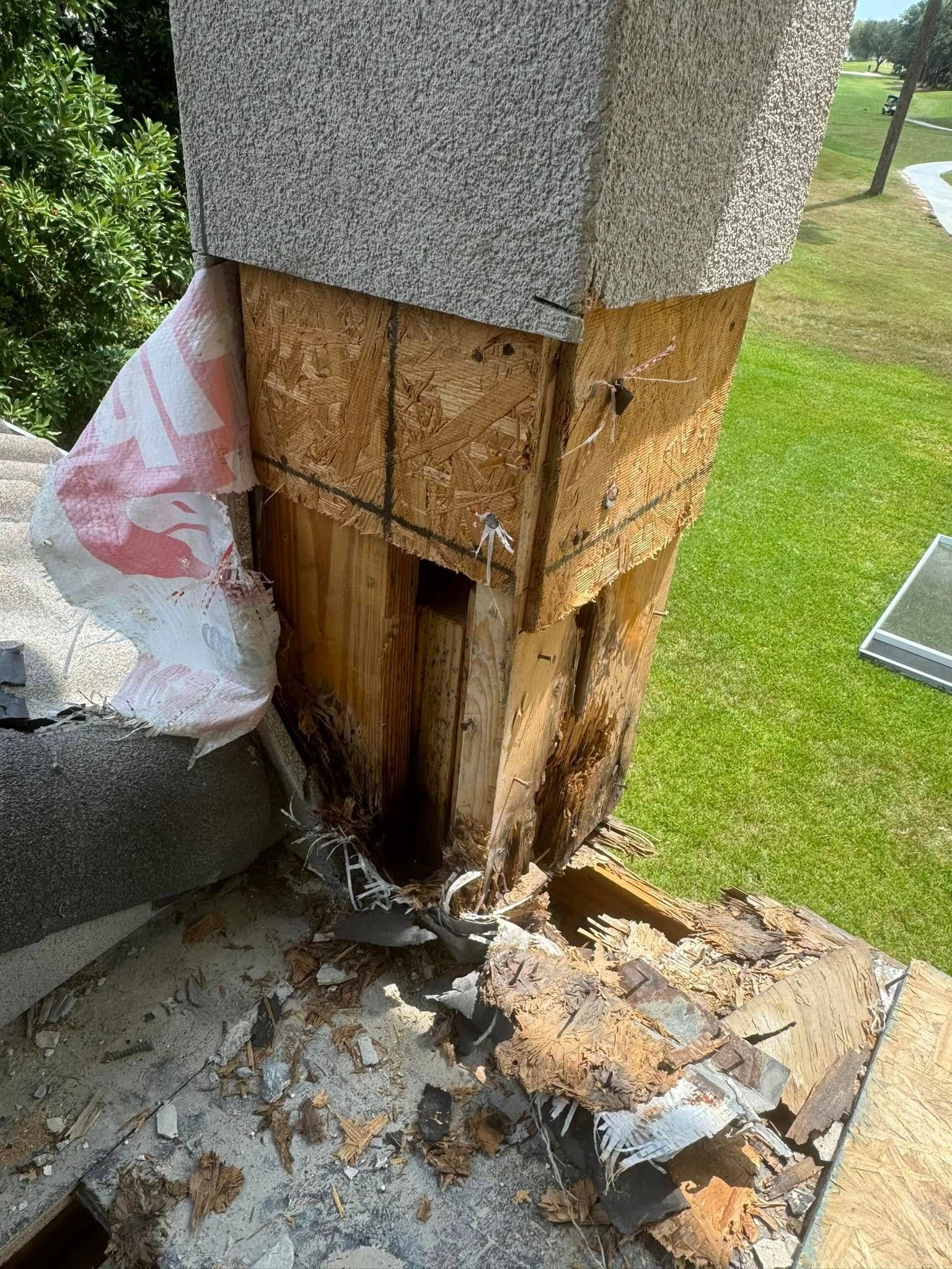 A chimney is being removed from a roof.