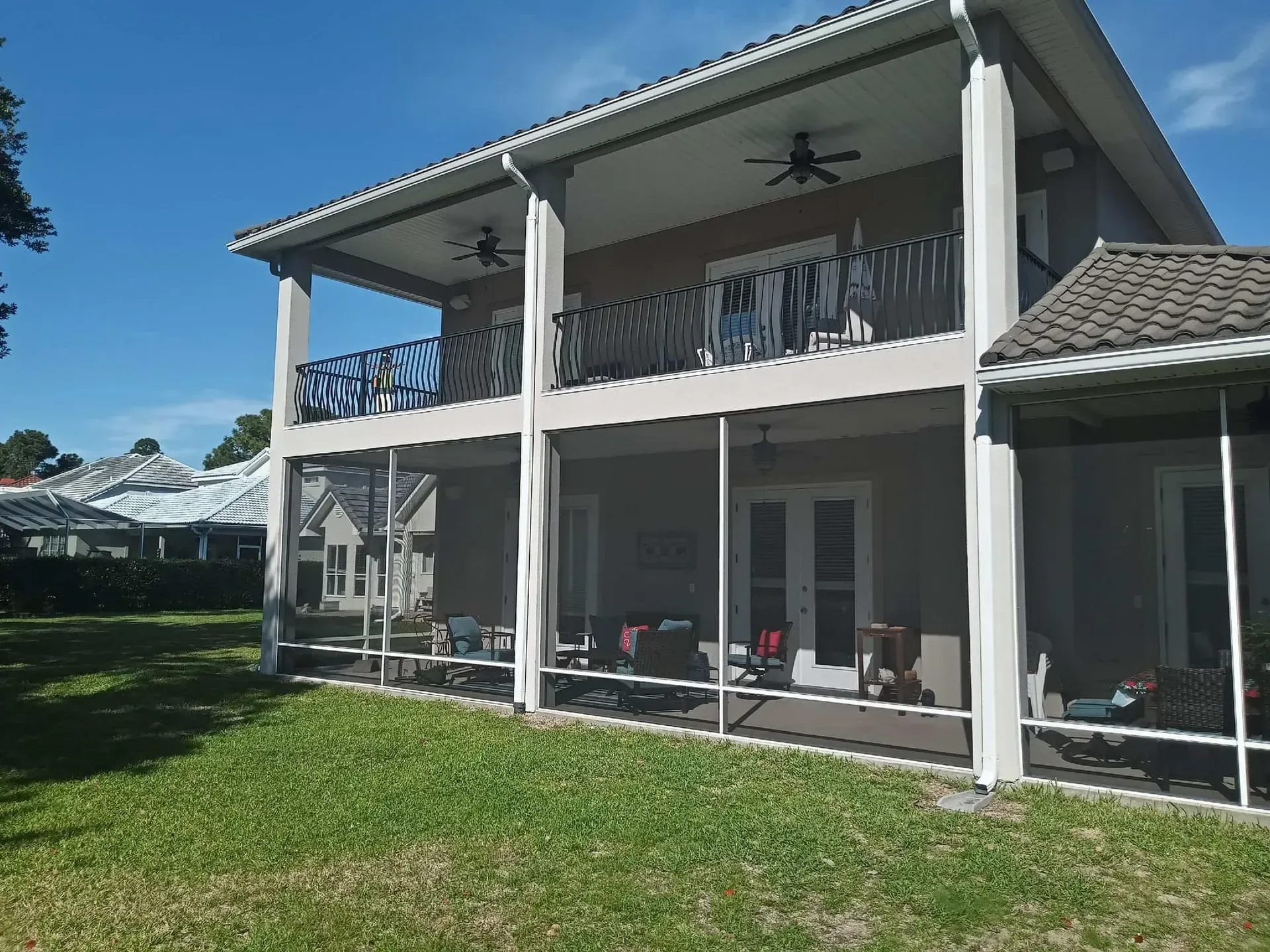 A large house with a screened in porch and balconies