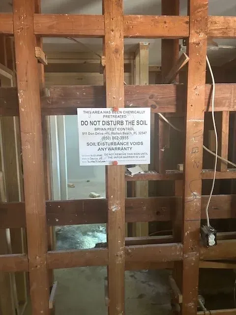 A wooden wall with a sign that says do not disturb the soil