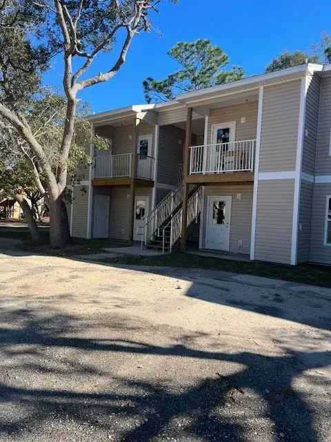 A large apartment building with stairs leading up to the second floor