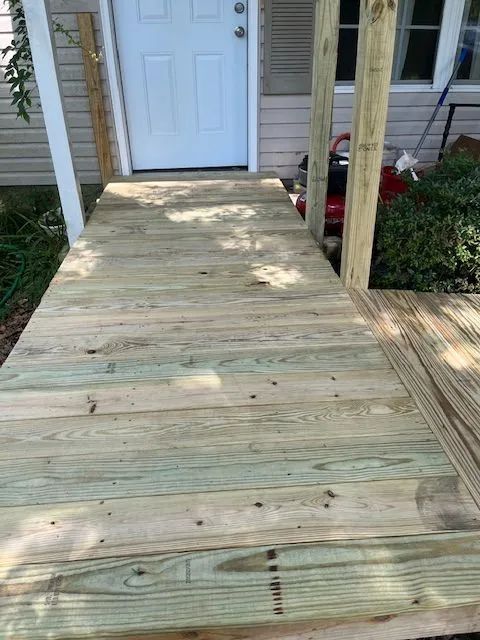 A wooden deck with stairs leading up to it
