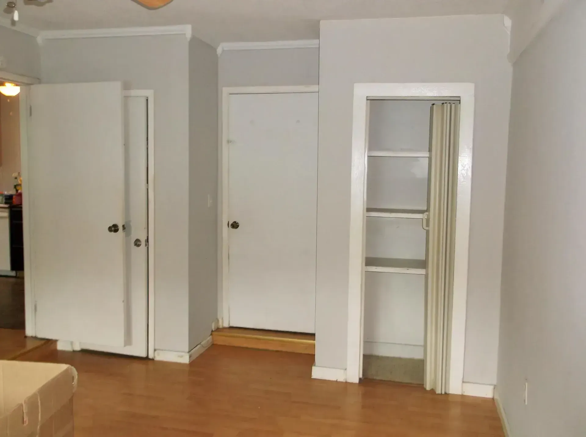 An empty room with a bed and a closet