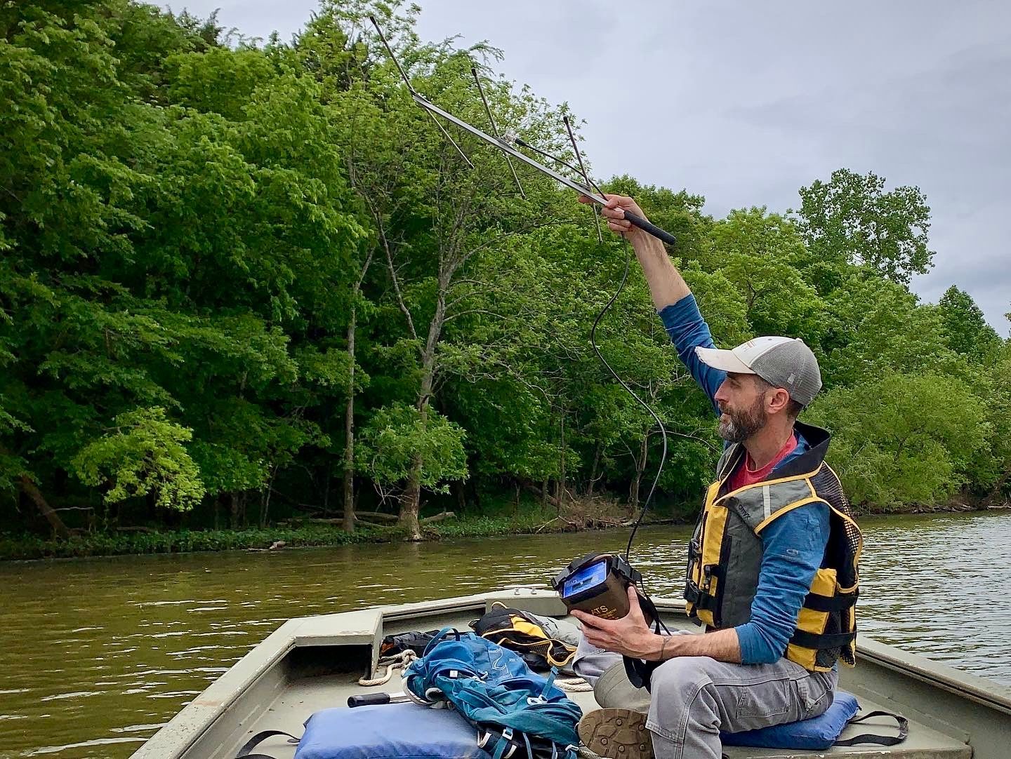 Dan Cox, Co-founder and Principal Ecologist at Volant EcoServices, conducting bat radio telemetry from a boat