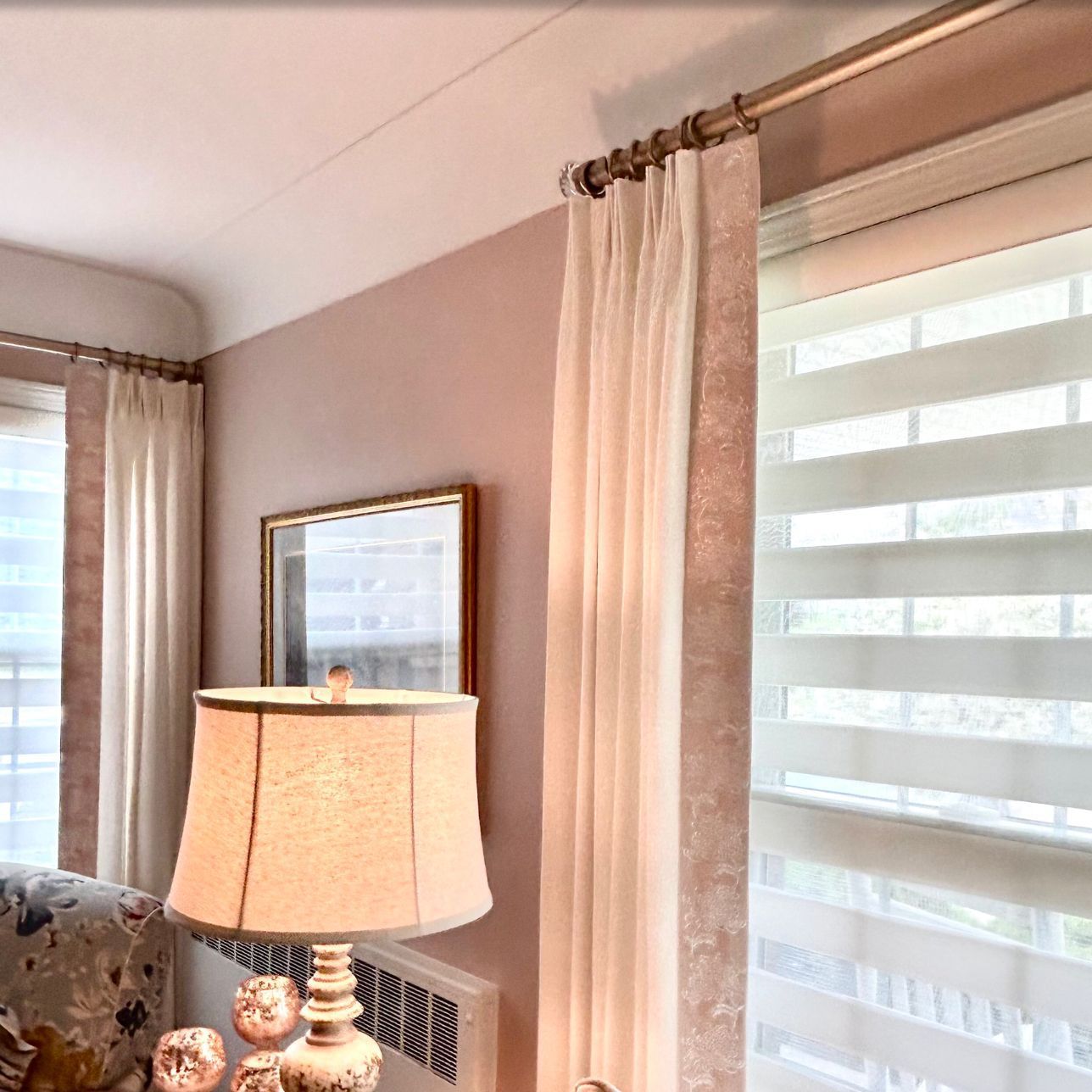 A bedroom with a bed, nightstands, and lamps.