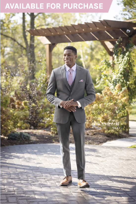 Man in a gray suit standing under a wooden pergola in a sunlit garden path, with “Available for Purchase” banner.