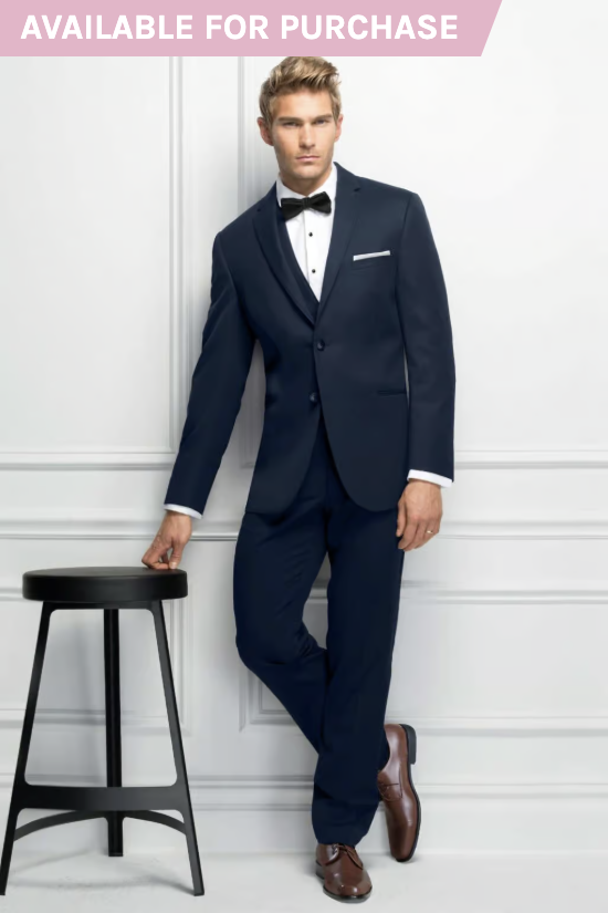 Man in navy suit leaning on a stool against a white wall, with “AVAILABLE FOR PURCHASE” banner.